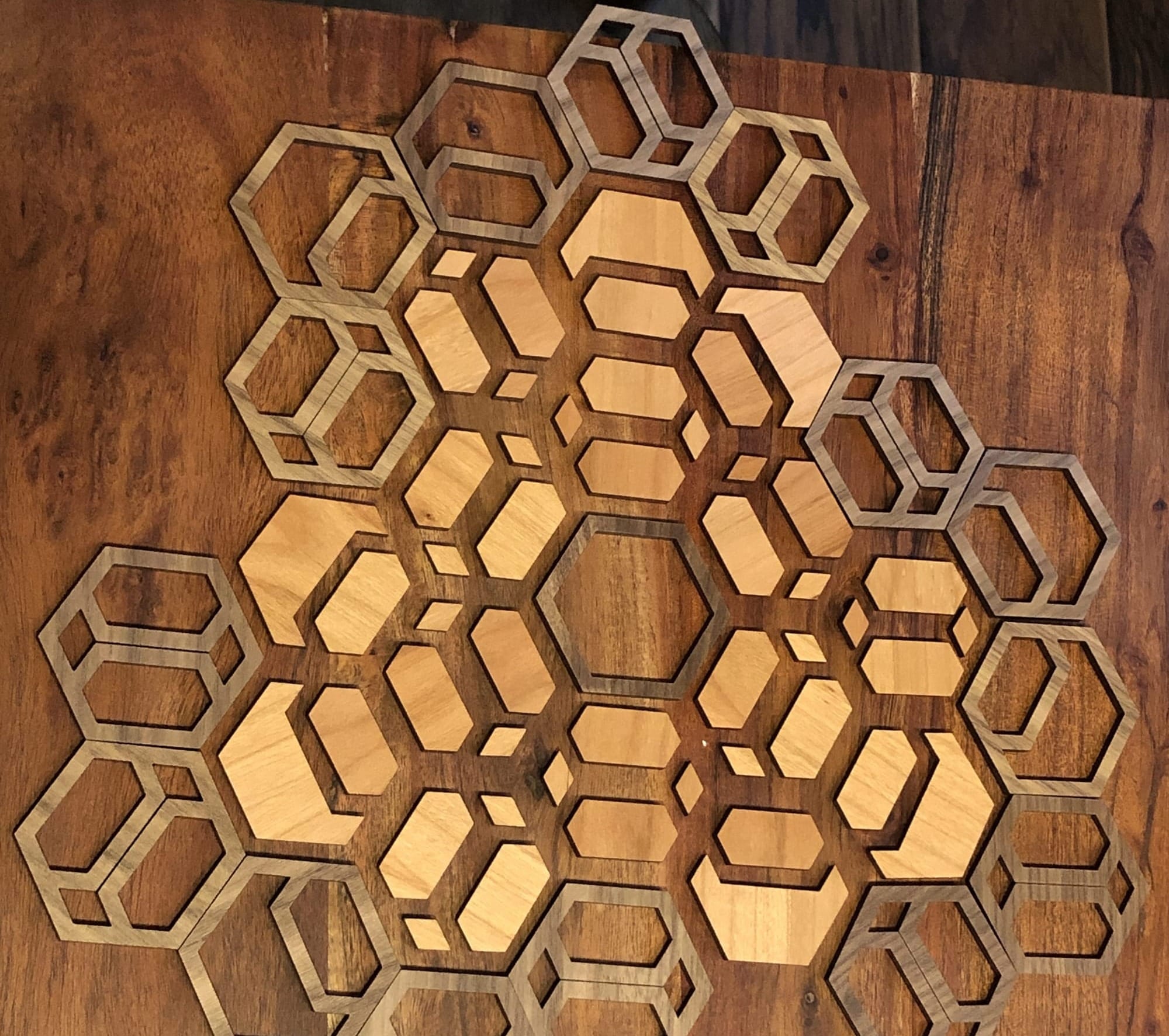 hexagonal laser cut tiles arranged in an artistic display