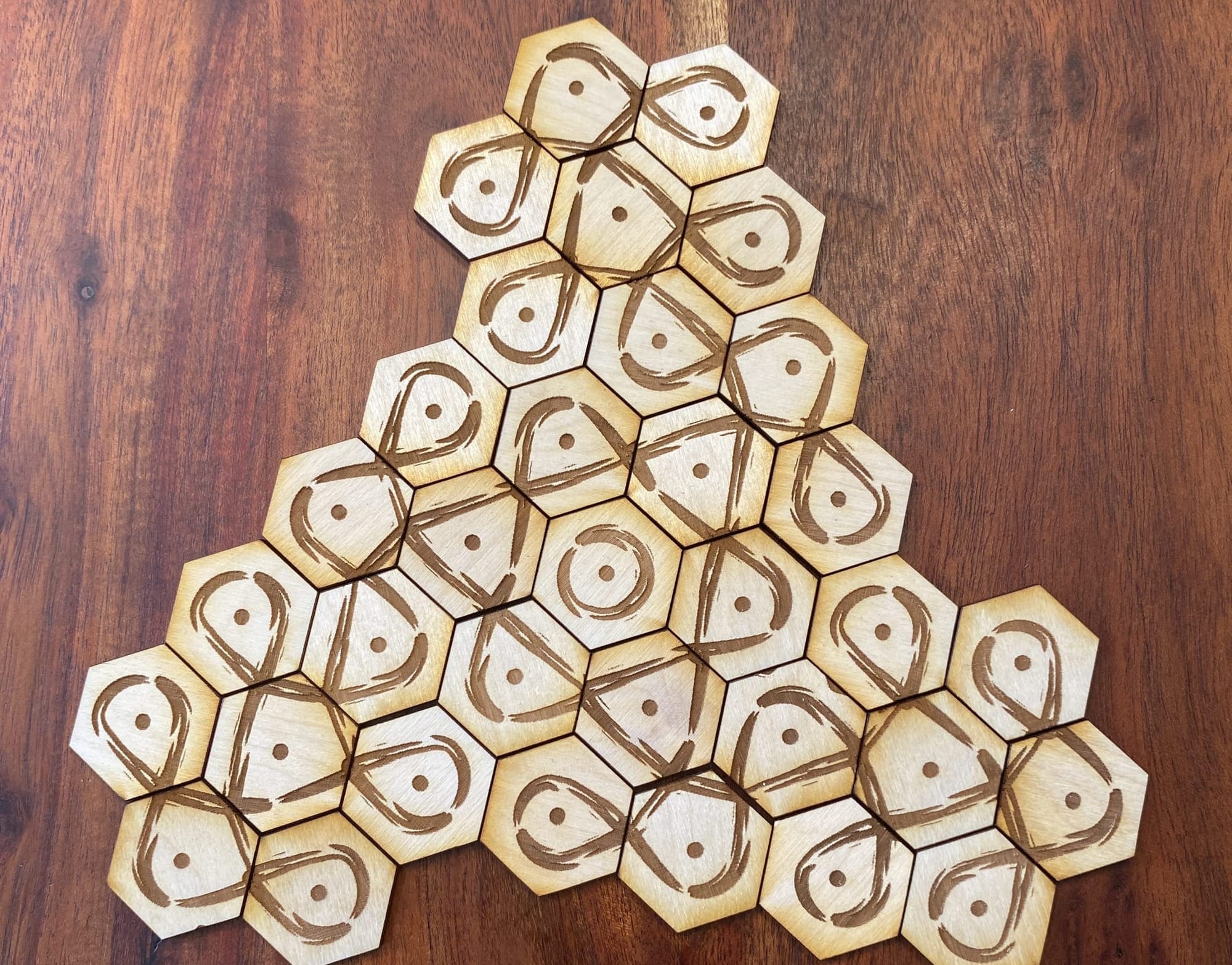 hexagonal tiles with kolam designs laid out with rotational symmetry