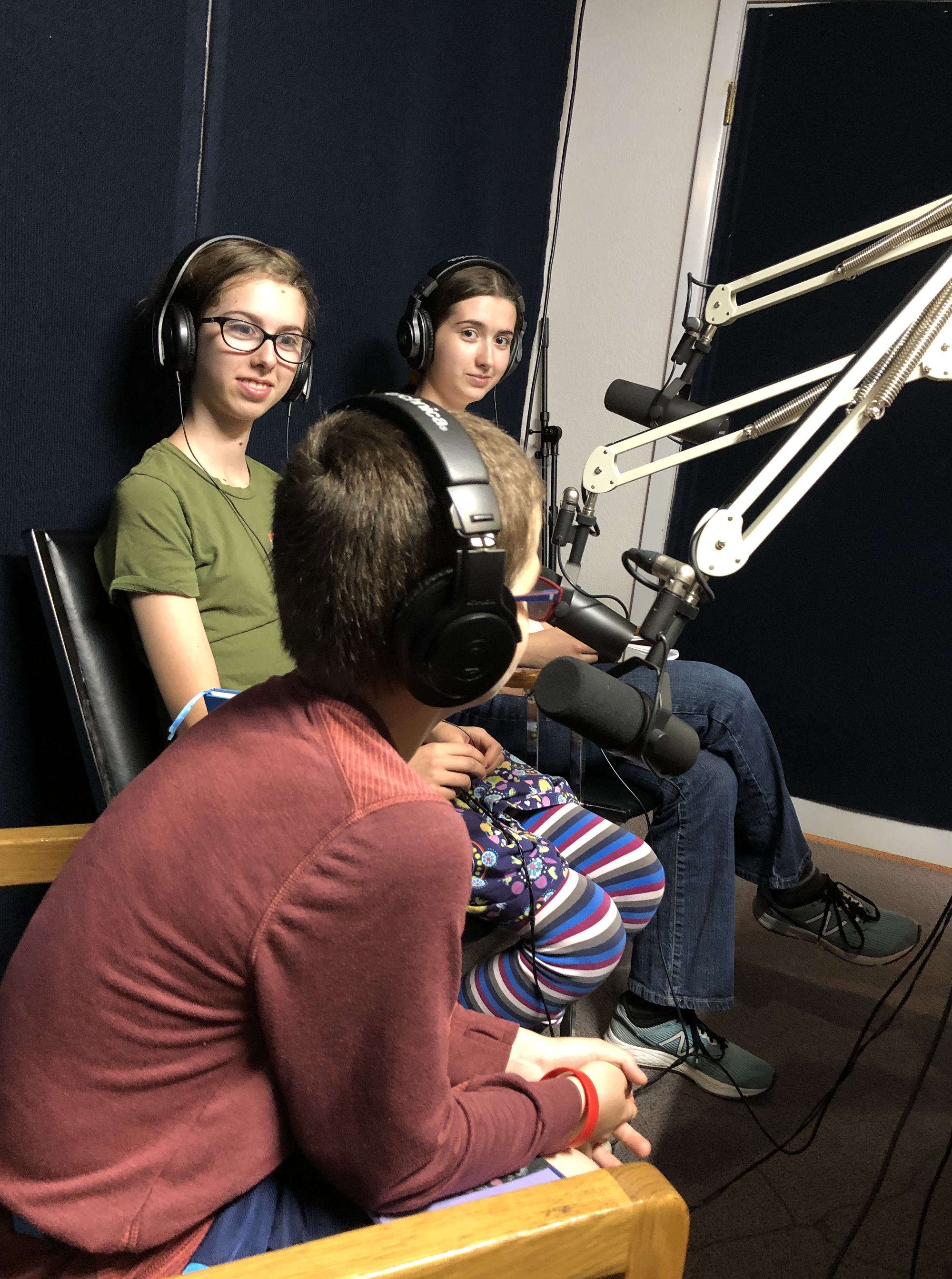 three kids sitting in a radio room