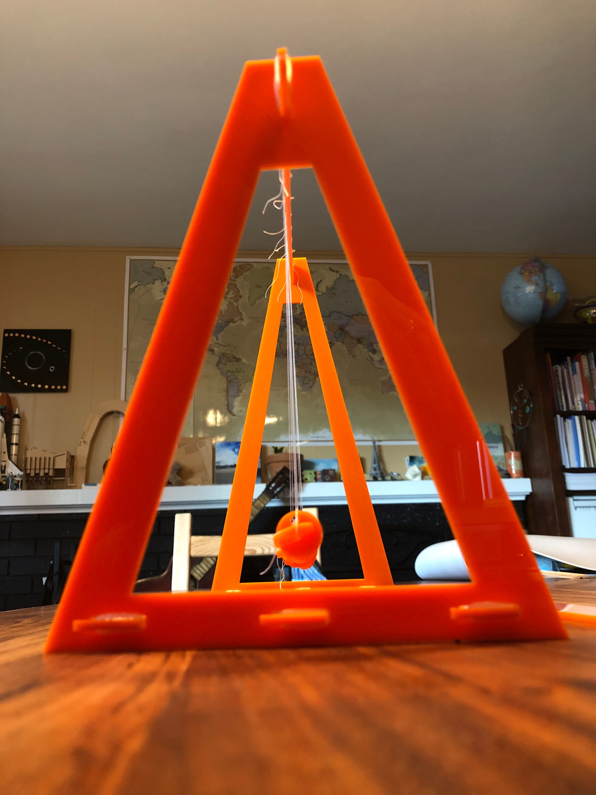 a picture of an orange wave pendulum looking down the line