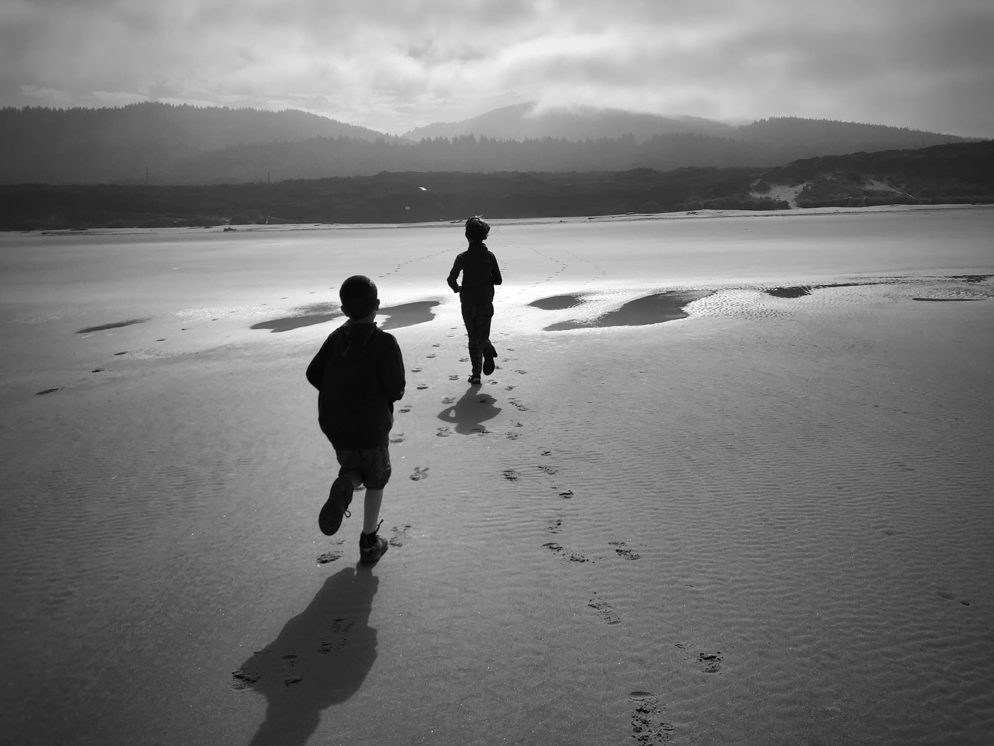 two kids running at the beach