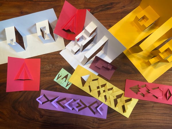 a scattering of kirigami on a table of many colors