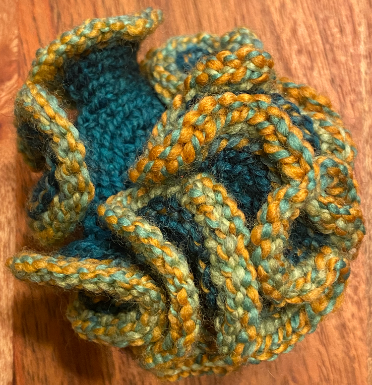 a hyperbolic yarn lovey with yellows greens and blues