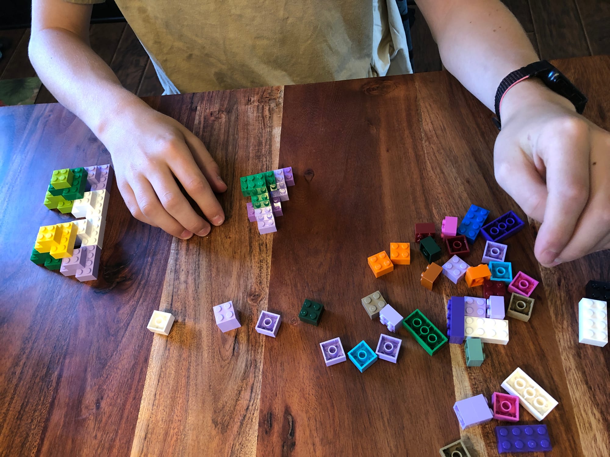 hands playing with legos