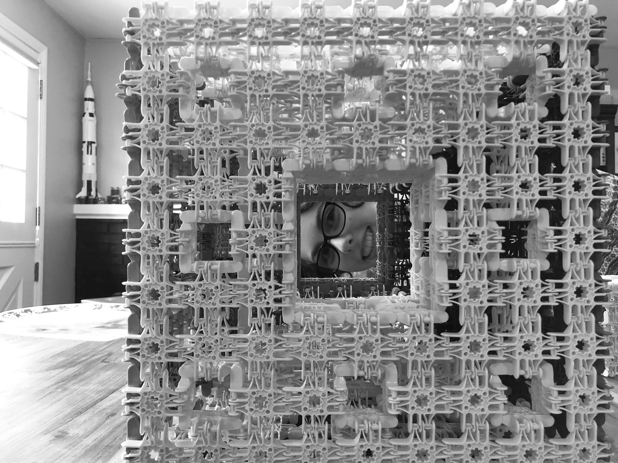 a kid looking through a toy-built menger sponge