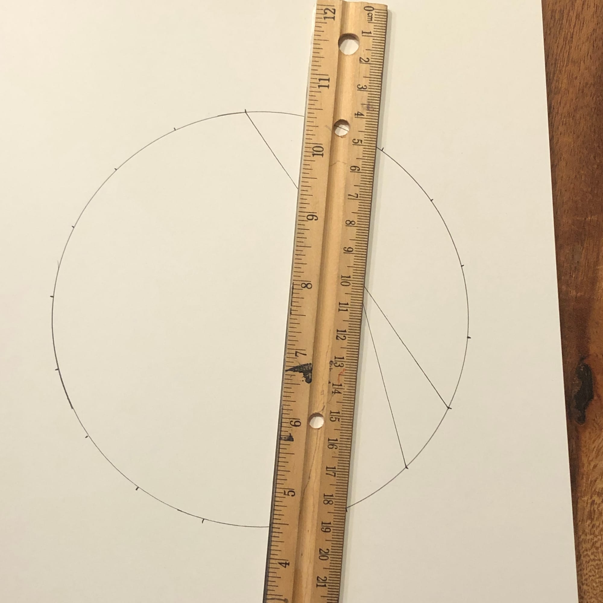 a circle with ruler and 2 lines drawn