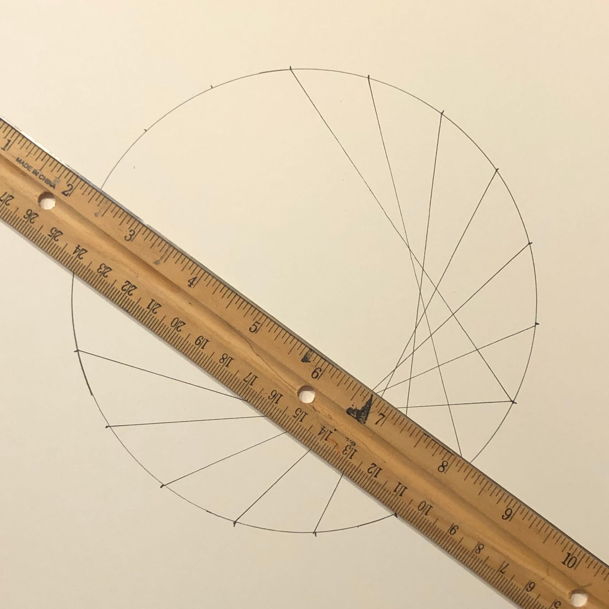 a circle with ruler and 8 lines drawn