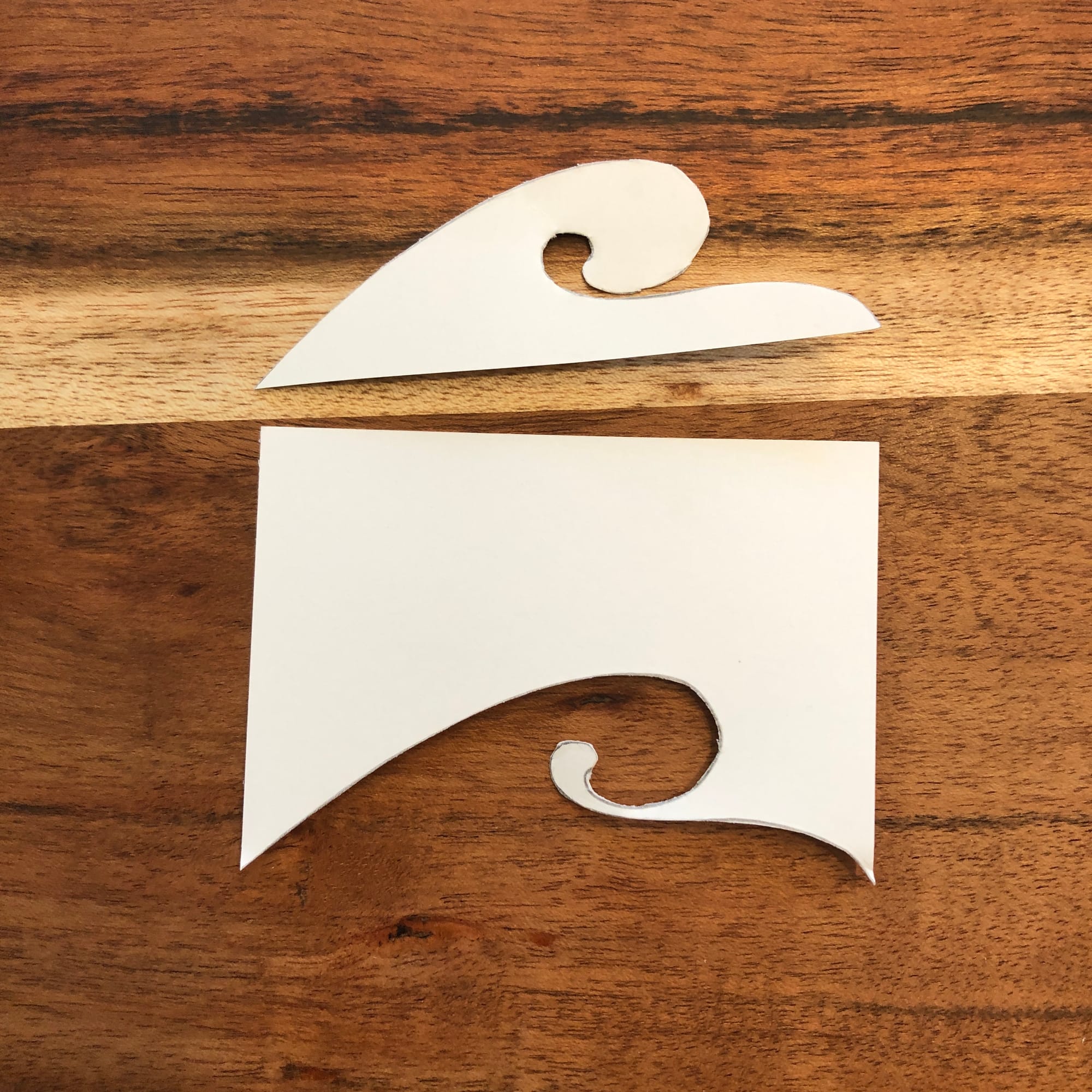 a wave shape cut out and placed above the rectangle of paper