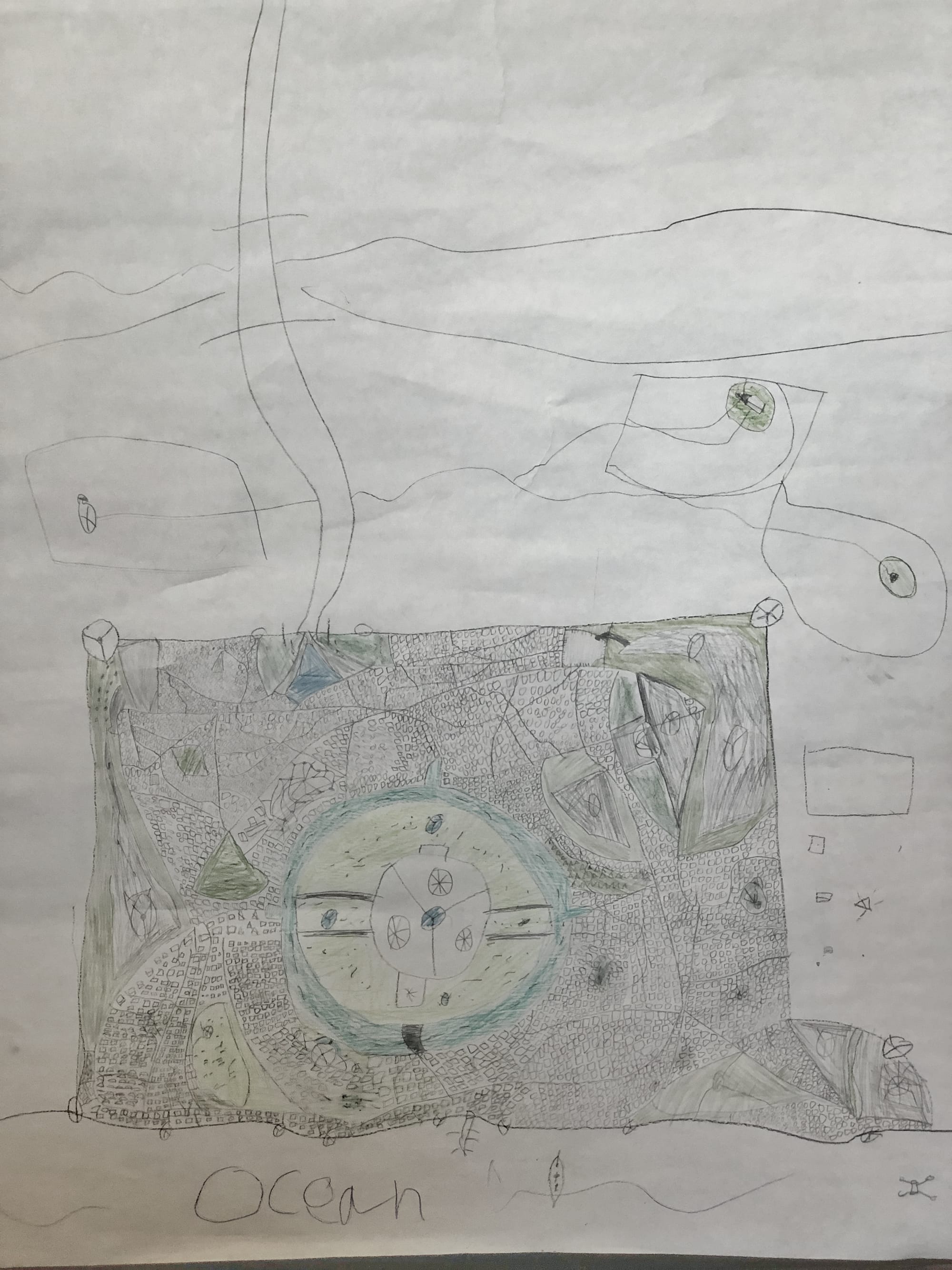 a large paper with of a child's map draw with and ocean and a city