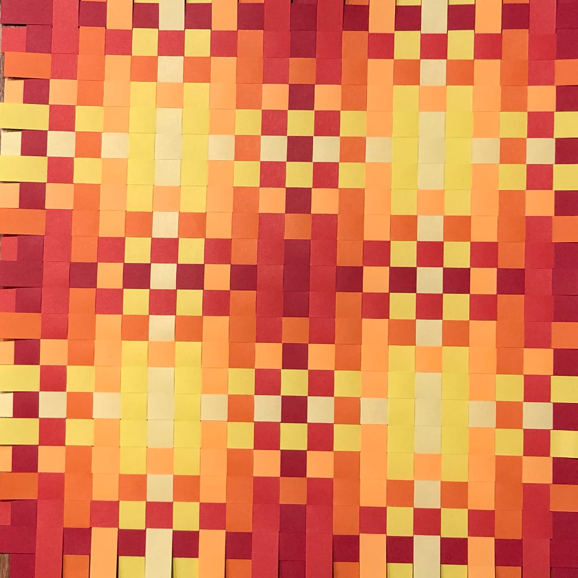 paper woven so that 4 yellow suns repeat with red, yellow and red