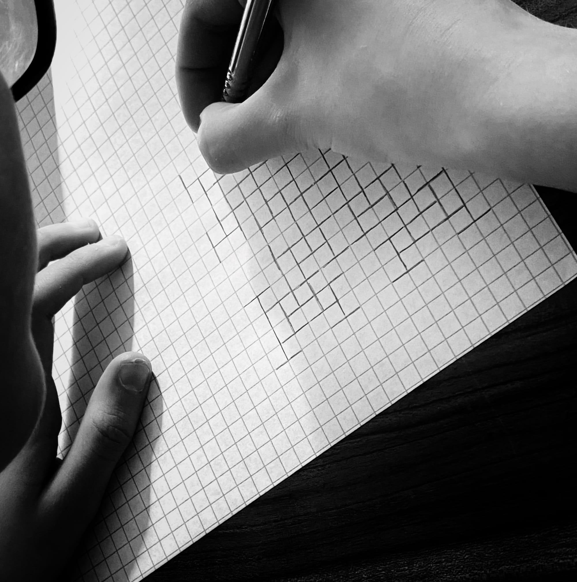 a student making a fractal on graph paper