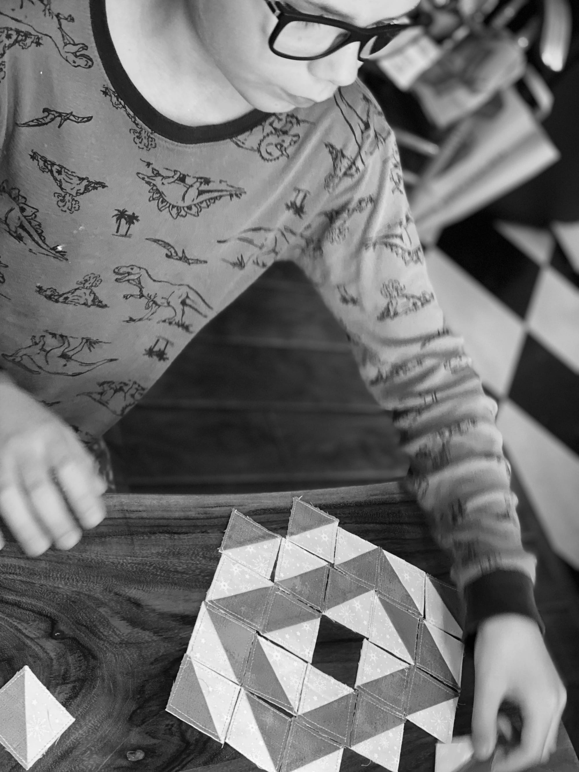 a person playing with cloth truchet tiles