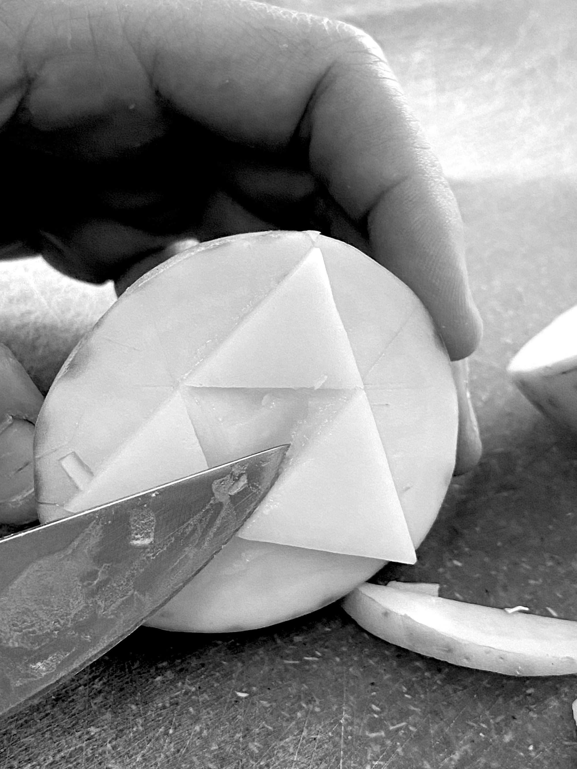 a knife cutting a sierpinski triangle in a potato