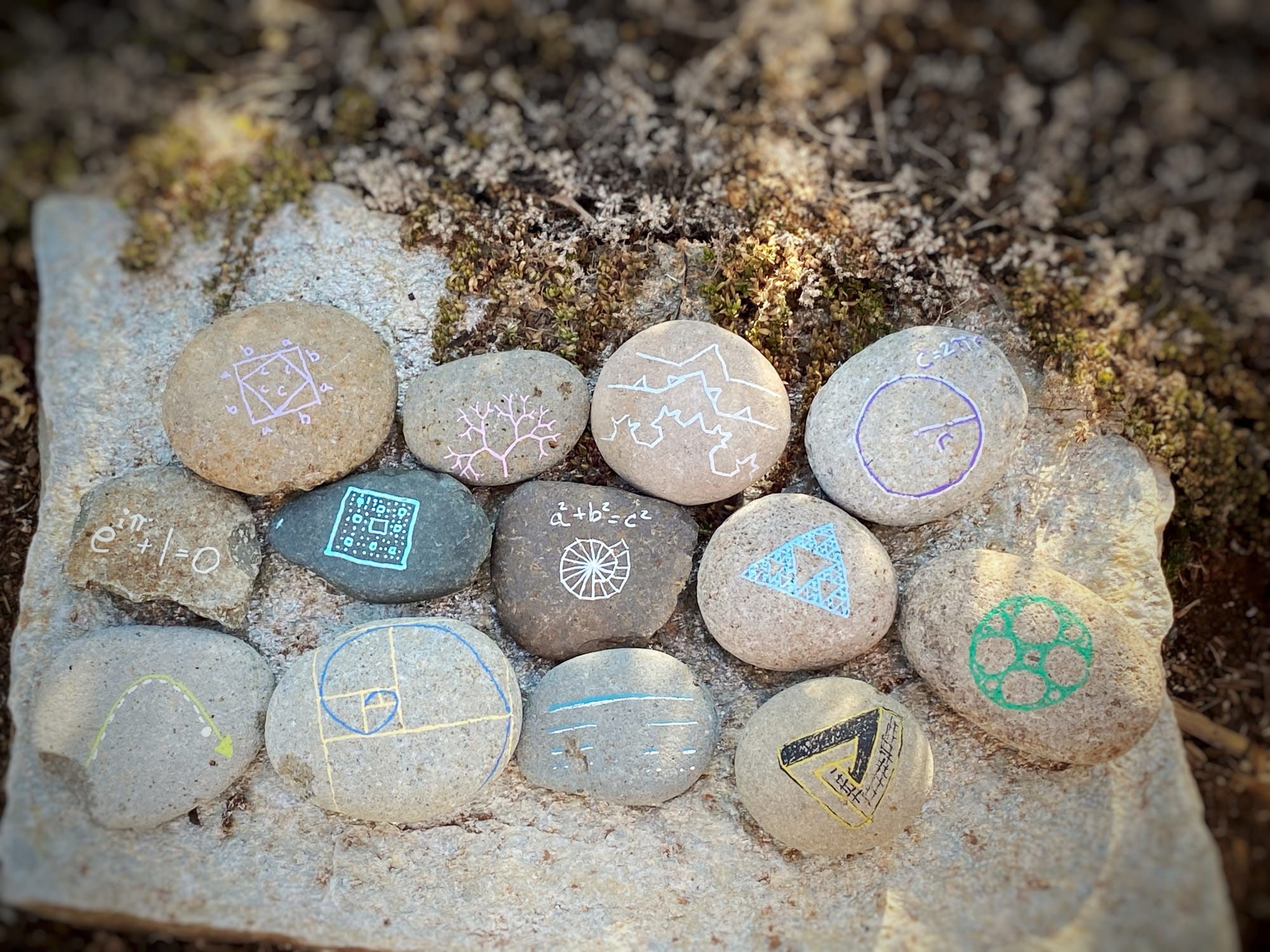 rocks painted with math drawings