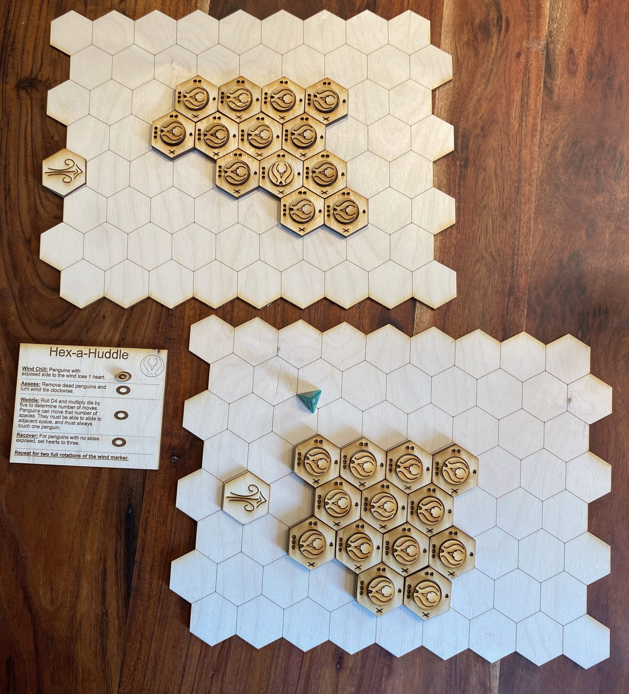 a laser cut board game made of hexagons and penguins