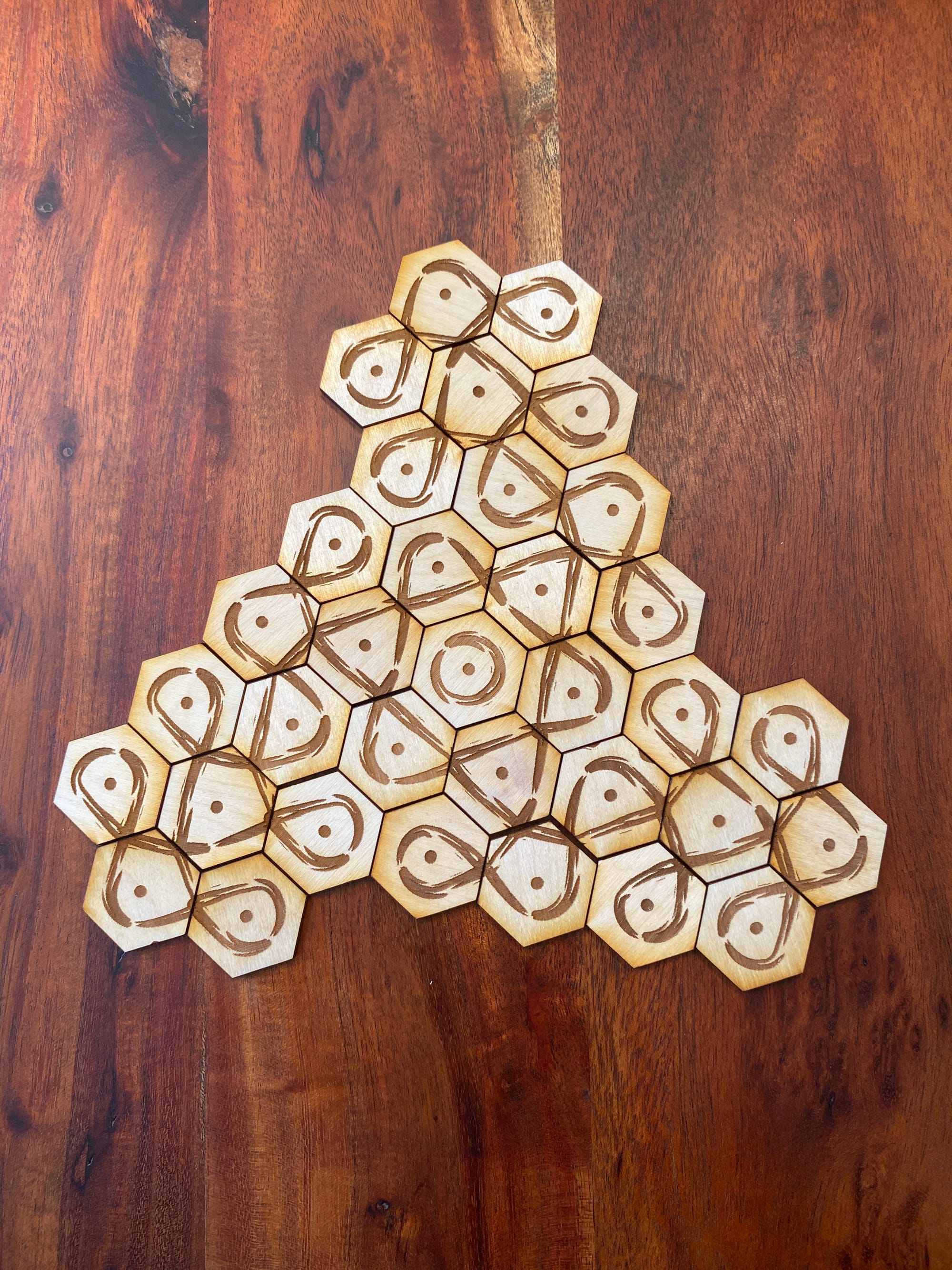 hexagonal kolam tiles cut from a laser